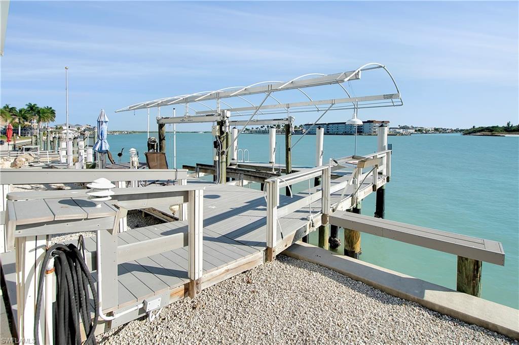 28 West Pelican Street Naples, FL 34113 - Photo 40 of 50 a view of a balcony with chairs