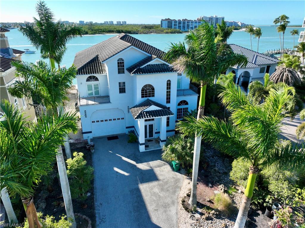28 West Pelican Street Naples, FL 34113 - Photo 5 of 50 a aerial view of a house with yard and sitting area