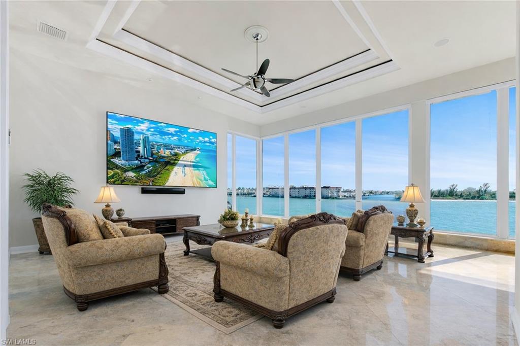 28 West Pelican Street Naples, FL 34113 - Photo 6 of 50 a living room with furniture a ceiling fan and a window