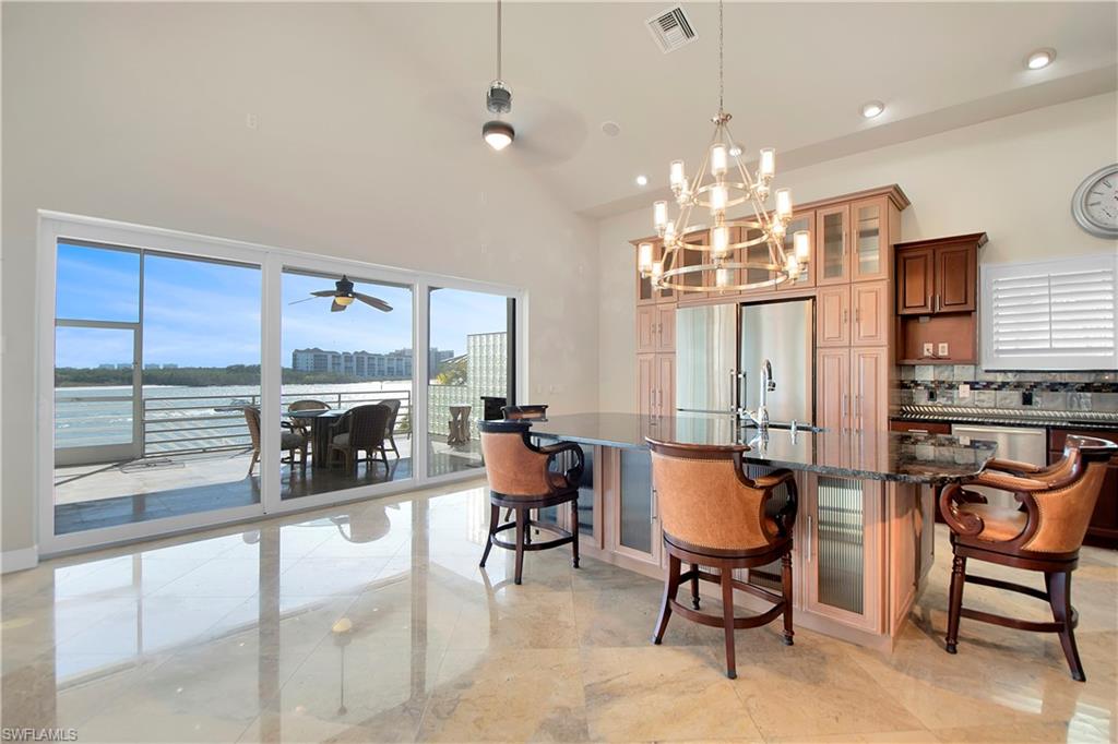 28 West Pelican Street Naples, FL 34113 - Photo 8 of 50 a view of a dining room with furniture window and outside view
