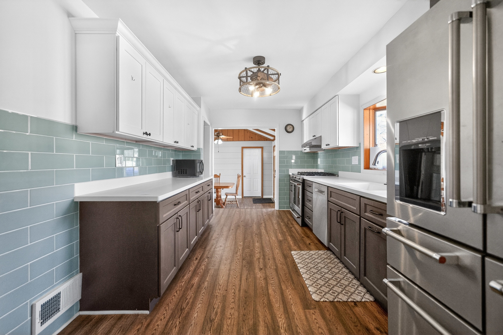 720 East Harrison Avenue Wheaton, IL 60187 - Photo 9 of 28 a kitchen with stainless steel appliances a sink wooden cabinets counter space and wooden floor