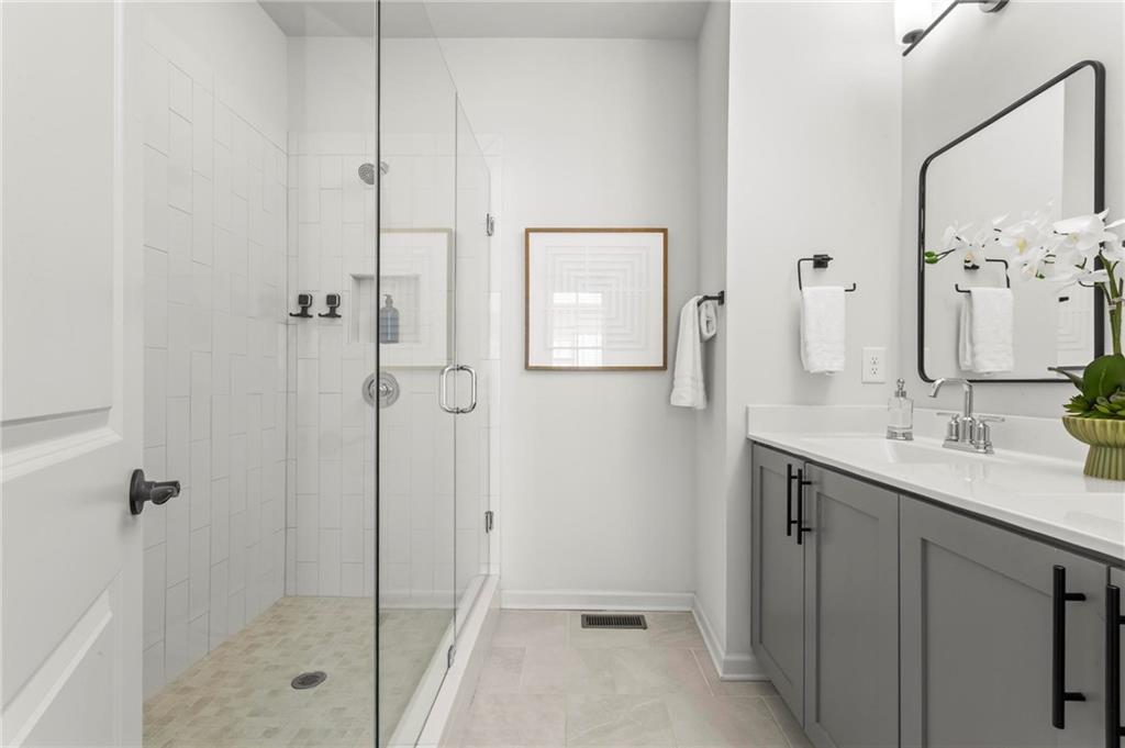 718 Needletail Way Atlanta, GA 30312 - Photo 22 of 44 a bathroom with a shower sink and mirror