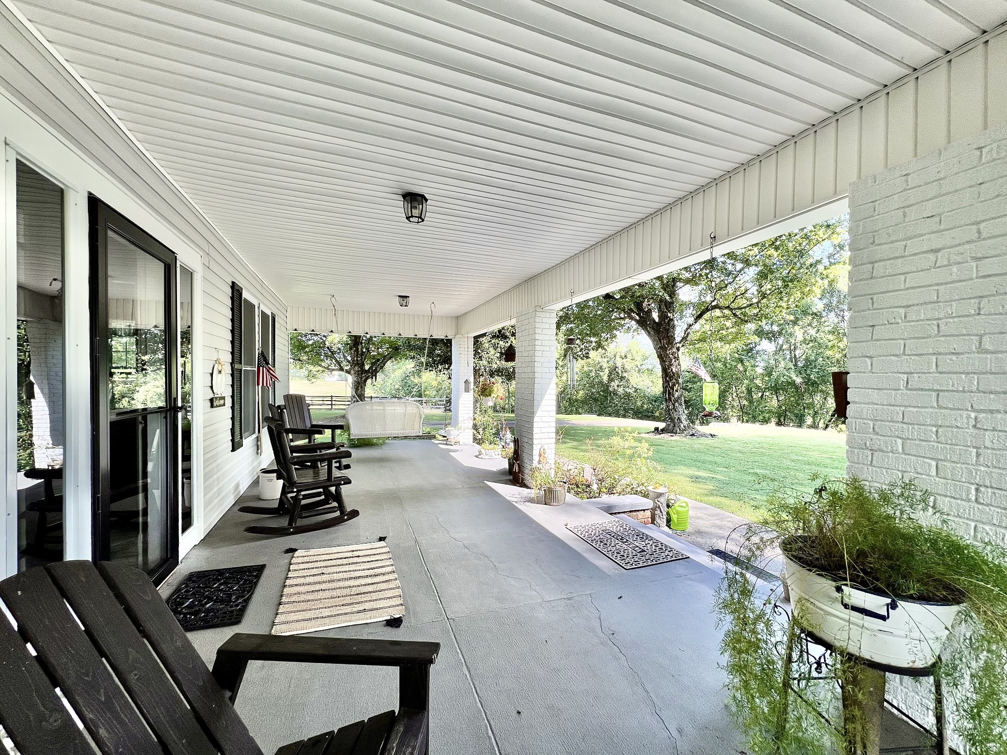 1400 Ragsdale Lane Pulaski, TN 38478 - Photo 11 of 100 a view of a patio with table and chairs barbeque potted plants and large tree
