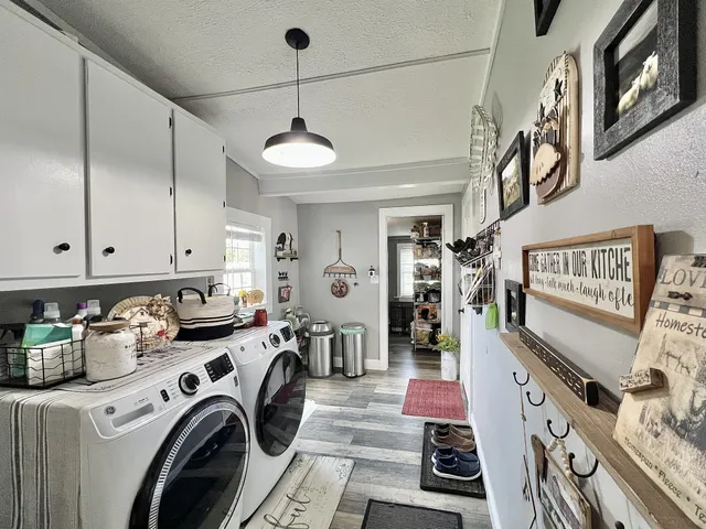 a spacious bathroom with a double vanity sink a mirror and a shower