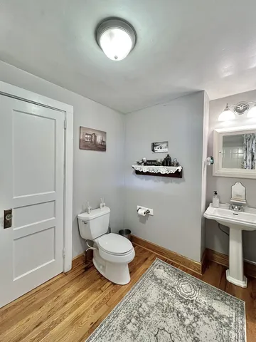 a living room with furniture a flat screen tv and kitchen view