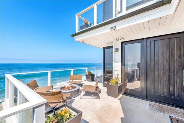 a view of outdoor kitchen with seating area