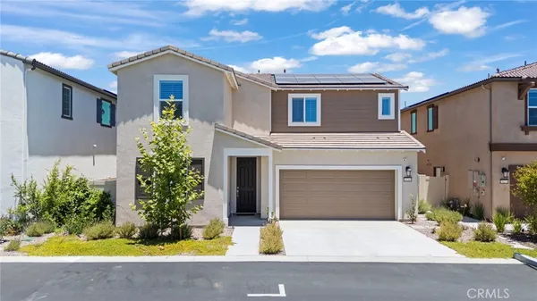 a front view of a house with yard