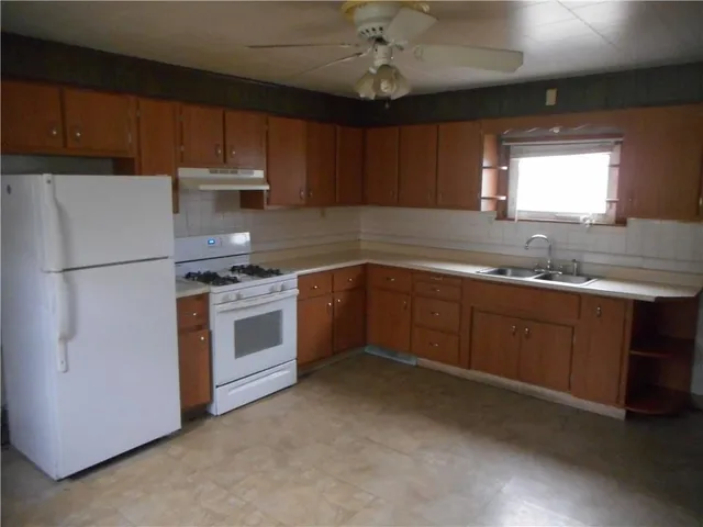 a kitchen with a sink stainless steel appliances and cabinets