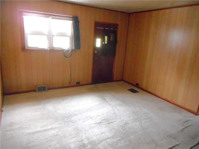 an empty room with windows and closet
