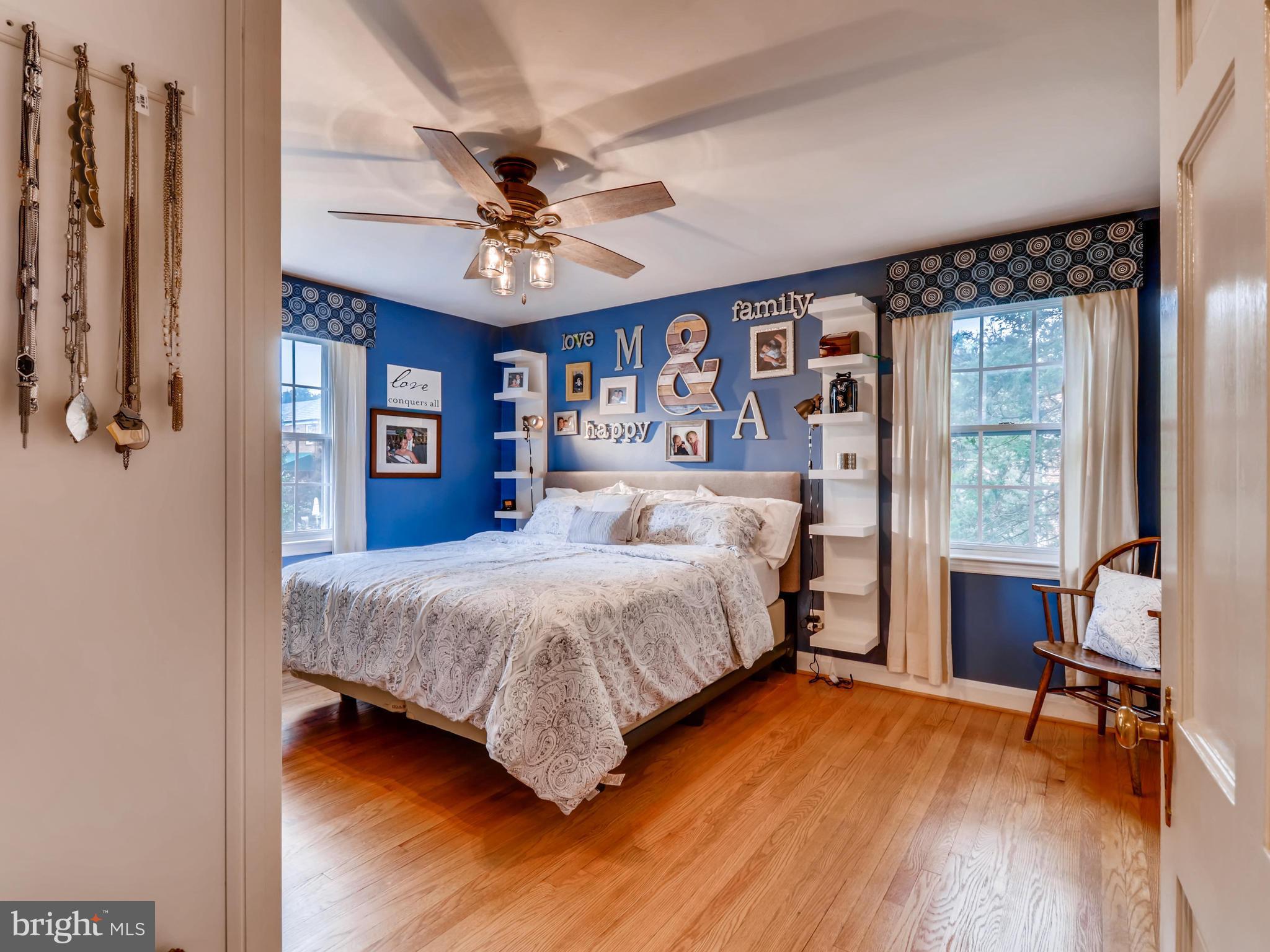 427 Stratford Road Baltimore, MD 21228 - Photo 15 of 29 a bedroom with a large bed a chandelier and a window
