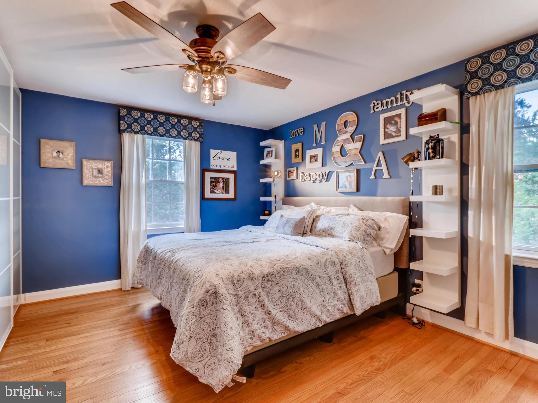 427 Stratford Road Baltimore, MD 21228 - Photo 16 of 29 a spacious bedroom with a bed and a chandelier