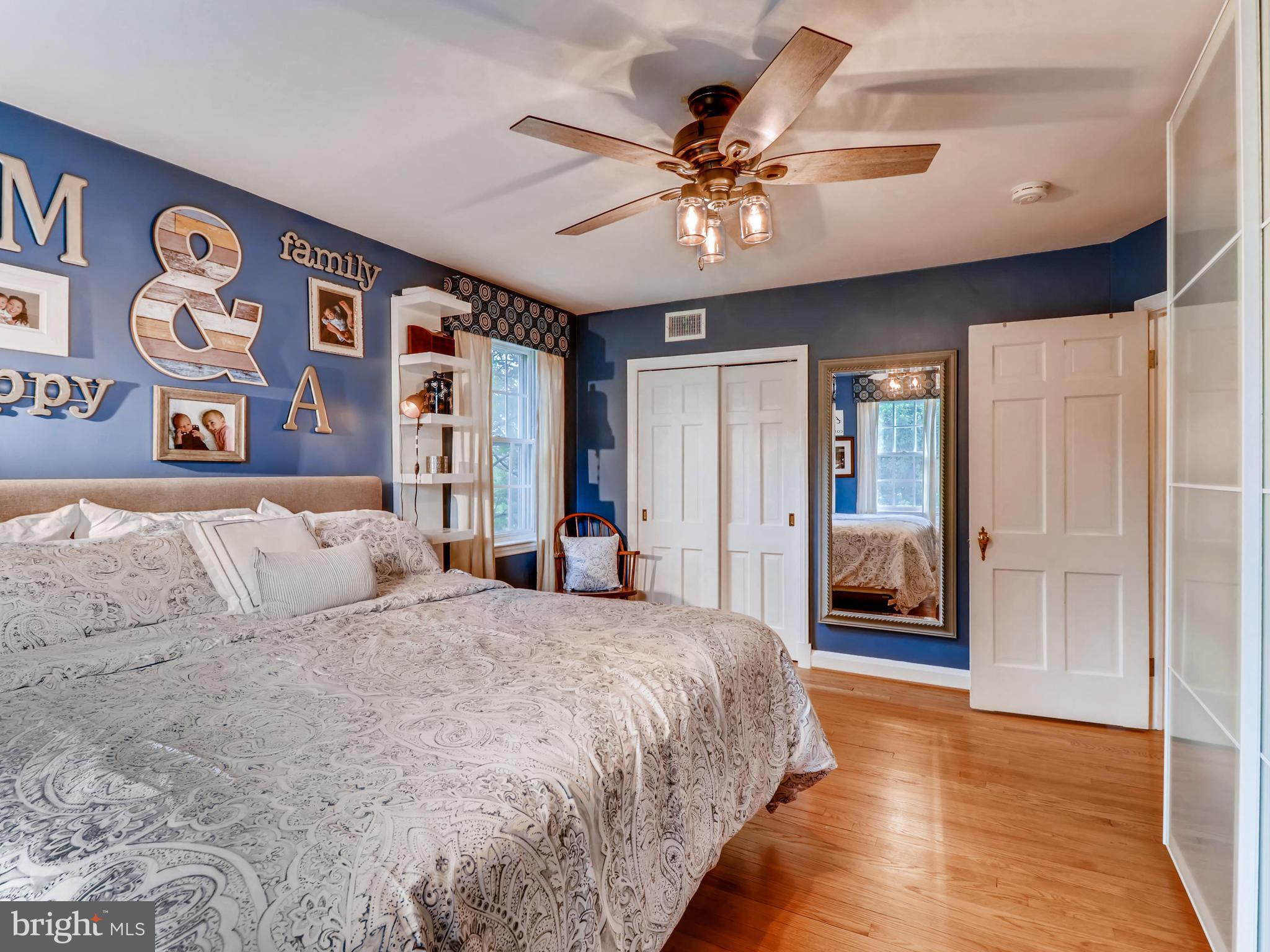 427 Stratford Road Baltimore, MD 21228 - Photo 17 of 29 a bedroom with a large bed and a chandelier