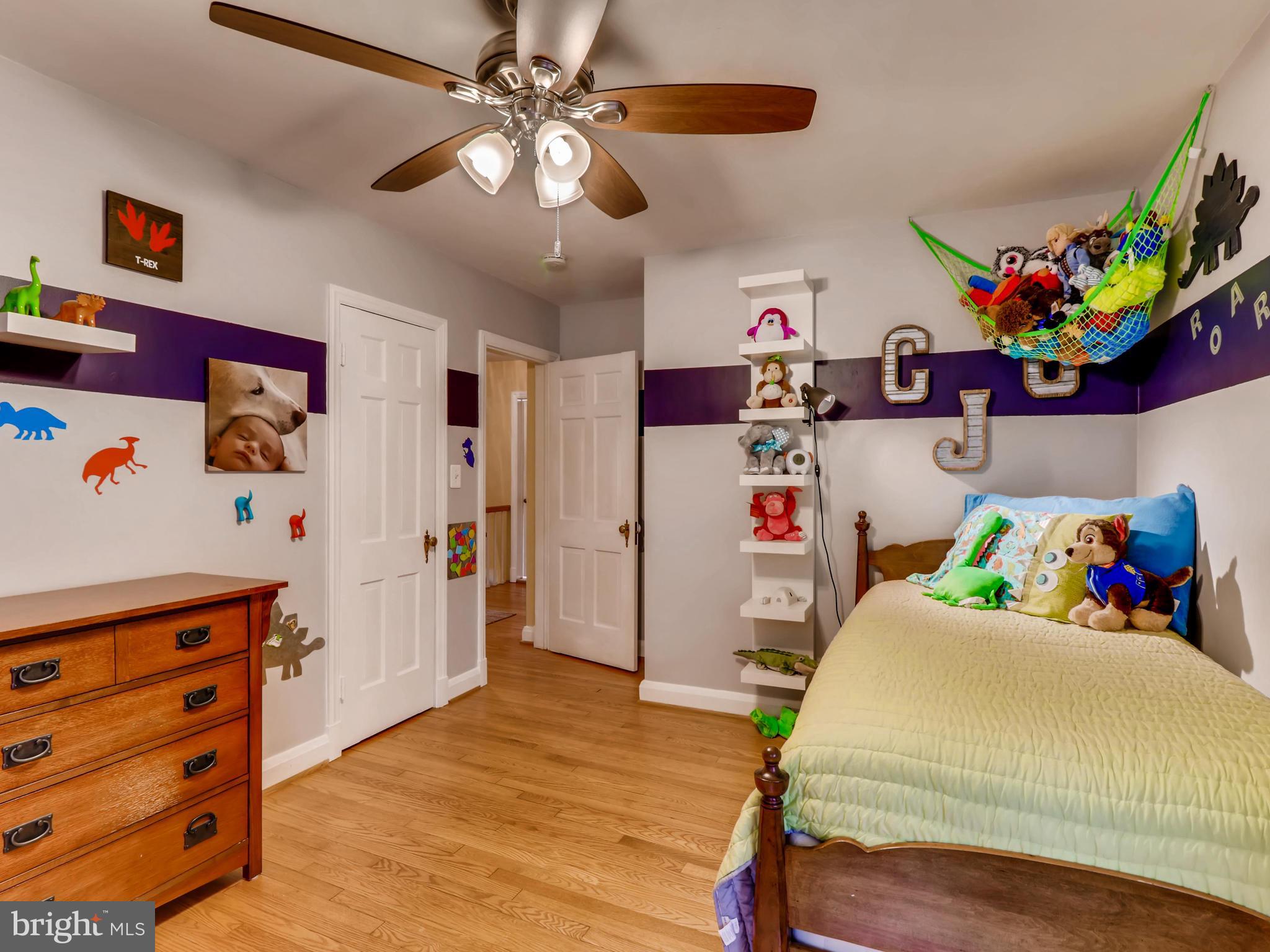 427 Stratford Road Baltimore, MD 21228 - Photo 20 of 29 a bedroom with a bed and wooden floor