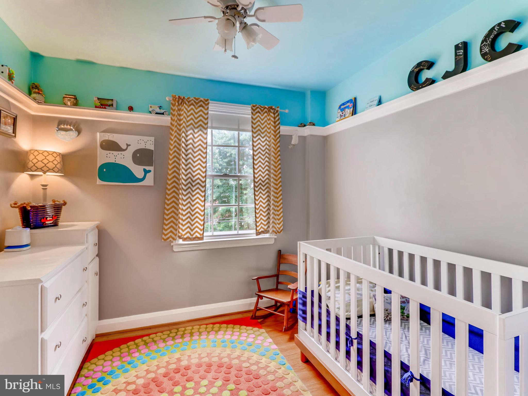 427 Stratford Road Baltimore, MD 21228 - Photo 21 of 29 a bedroom with furniture a baby crib and a window
