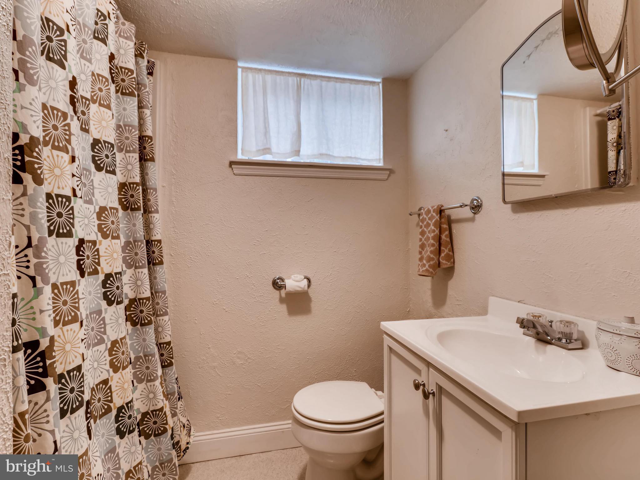 427 Stratford Road Baltimore, MD 21228 - Photo 25 of 29 a bathroom with a sink toilet and a mirror