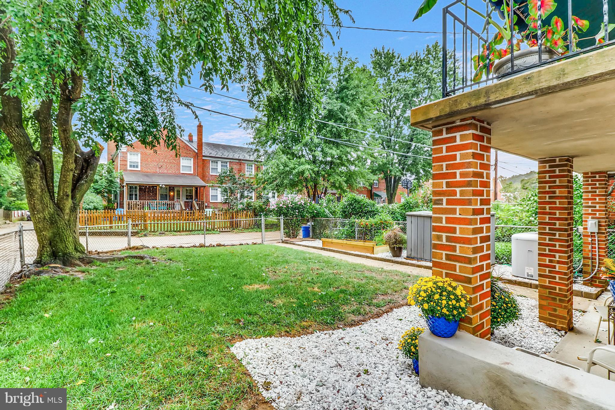 427 Stratford Road Baltimore, MD 21228 - Photo 28 of 29 a front view of a house with a yard fountain and a tree