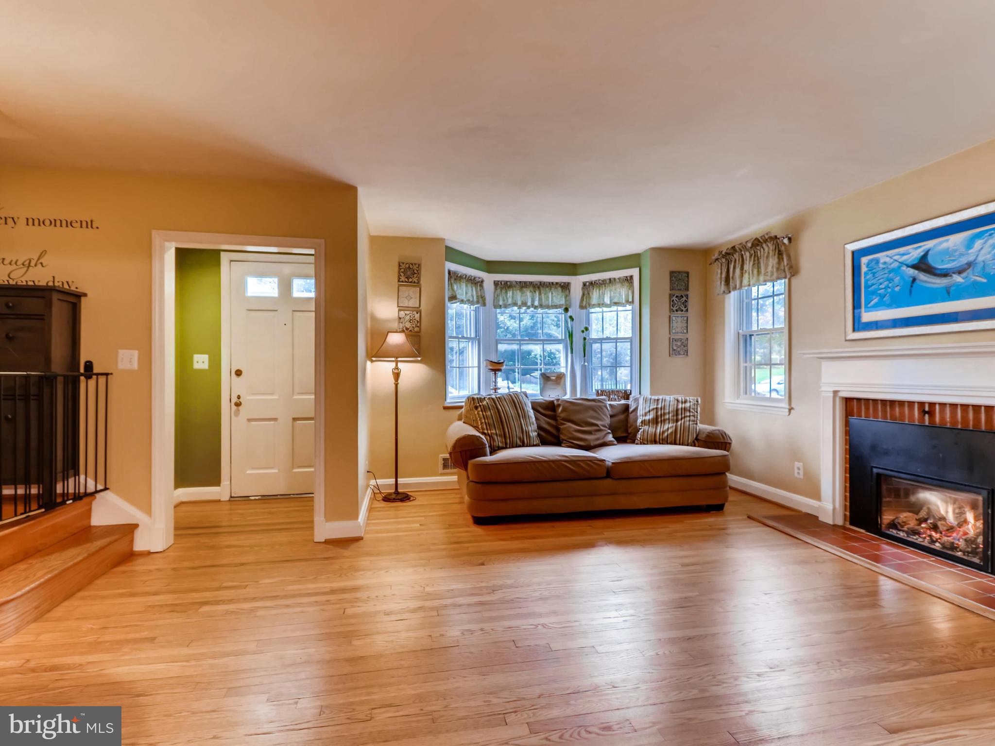 427 Stratford Road Baltimore, MD 21228 - Photo 7 of 29 a living room with fireplace furniture and a wooden floor