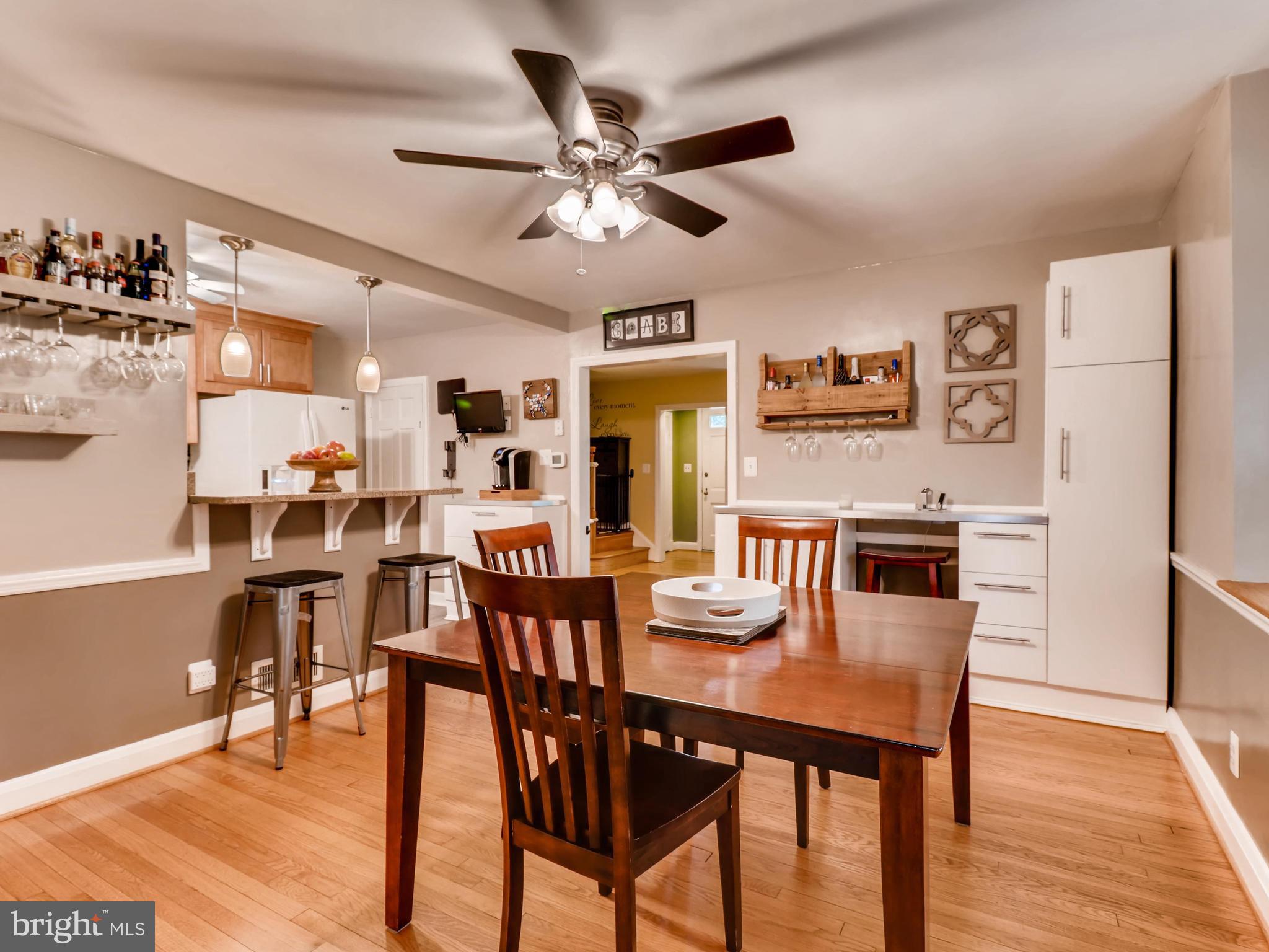 427 Stratford Road Baltimore, MD 21228 - Photo 9 of 29 a dining room with stainless steel appliances kitchen island granite countertop furniture and wooden floor