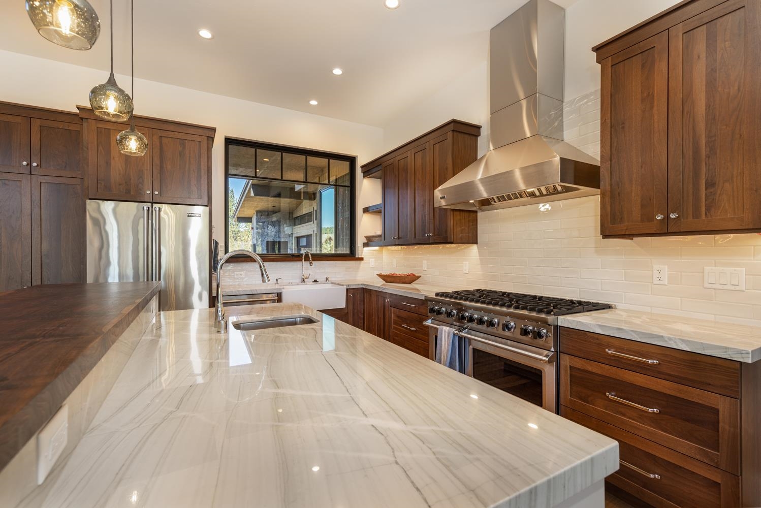 11654 Henness Road Truckee, CA 96161 - Photo 8 of 21 a kitchen with stainless steel appliances granite countertop a stove a sink dishwasher and a refrigerator with wooden floor