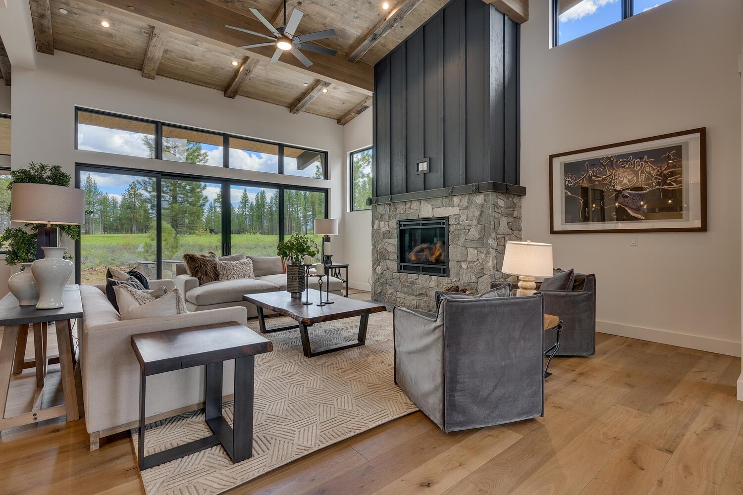 11654 Henness Road Truckee, CA 96161 - Photo 10 of 21 a living room with furniture a fireplace and a floor to ceiling window