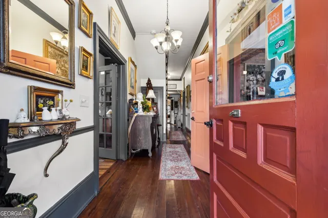 a living room with lots of furniture and paintings on the wall