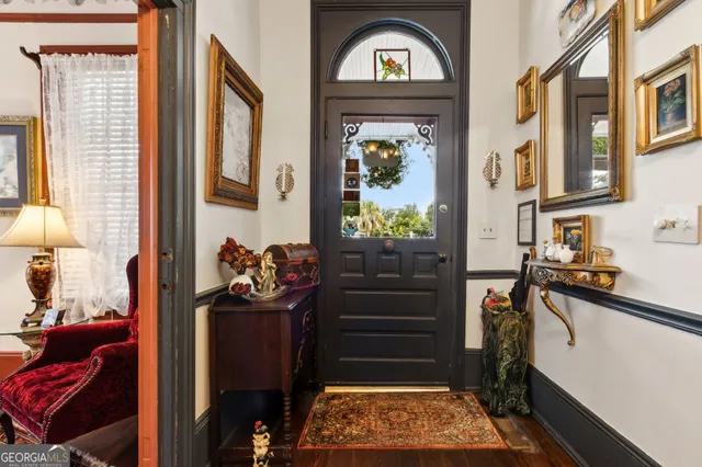 a view of a a dining room with furniture window and wooden floor