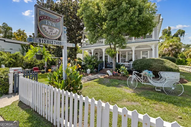 a view of a backyard with table and chairs and potted plants
