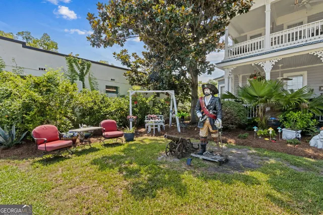 a view of a house with a yard porch and sitting area