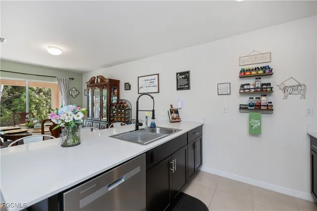 a kitchen with sink and view of living room
