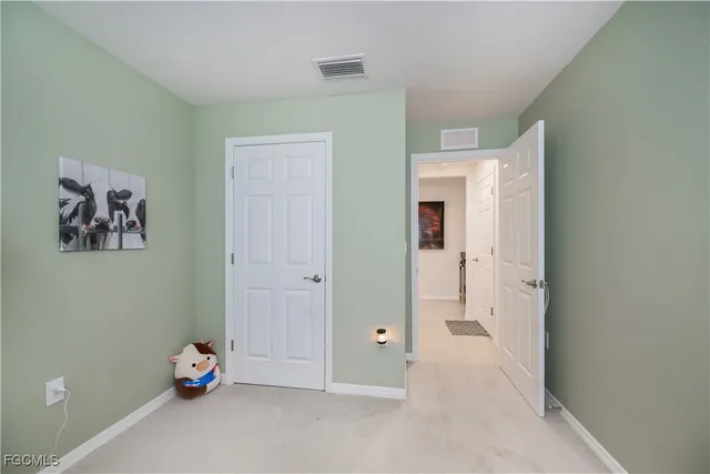 a view of room with hallway and closet
