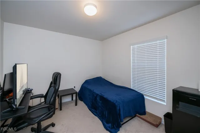 a living room with furniture a flat screen tv and a wooden floor