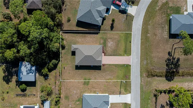an aerial view of a house with a yard
