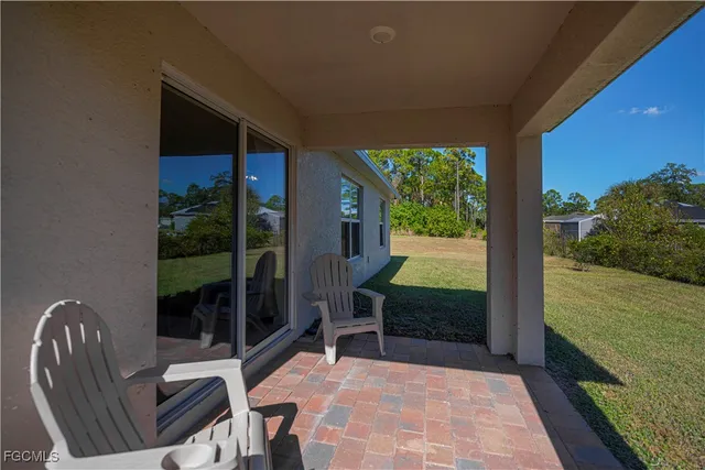 a view of a porch with furniture and garden