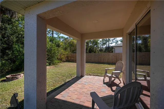 a view of an outdoor dining space with furniture window and outside view