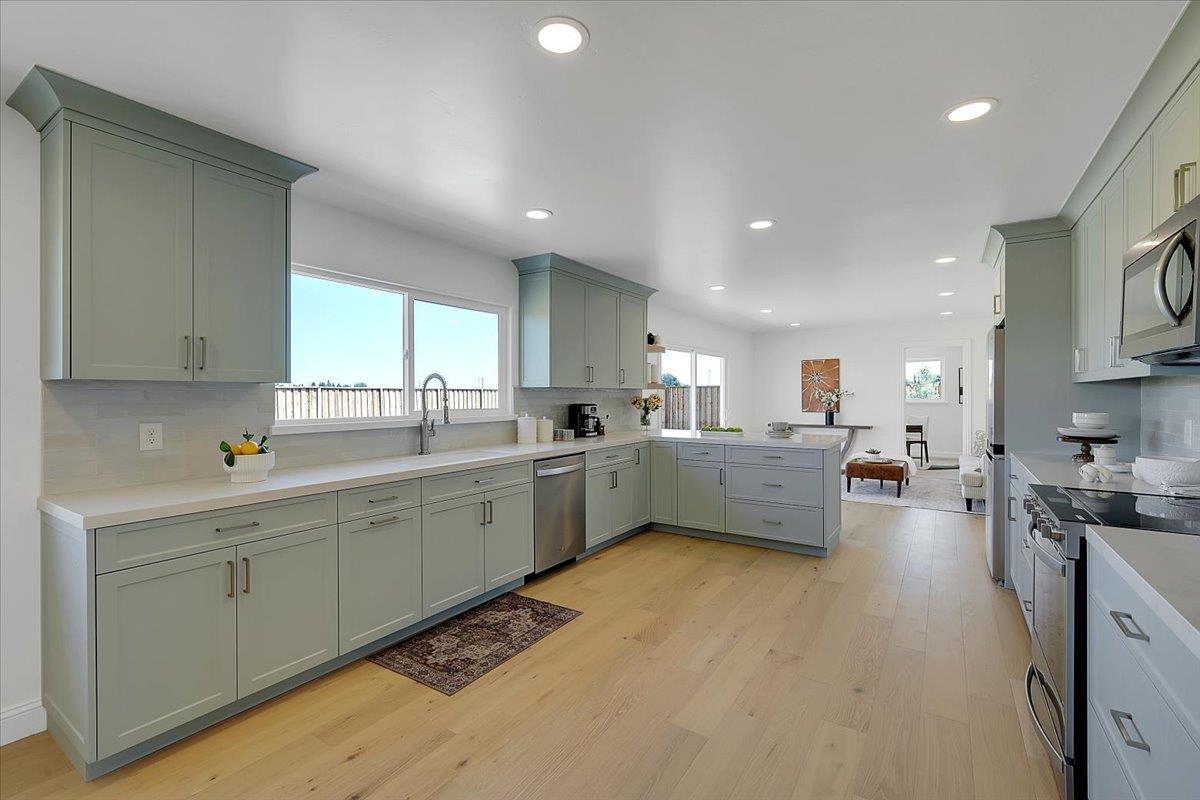 1181 Barry Road Yuba City, CA 95991 - Photo 16 of 60 a kitchen with sink refrigerator and cabinets
