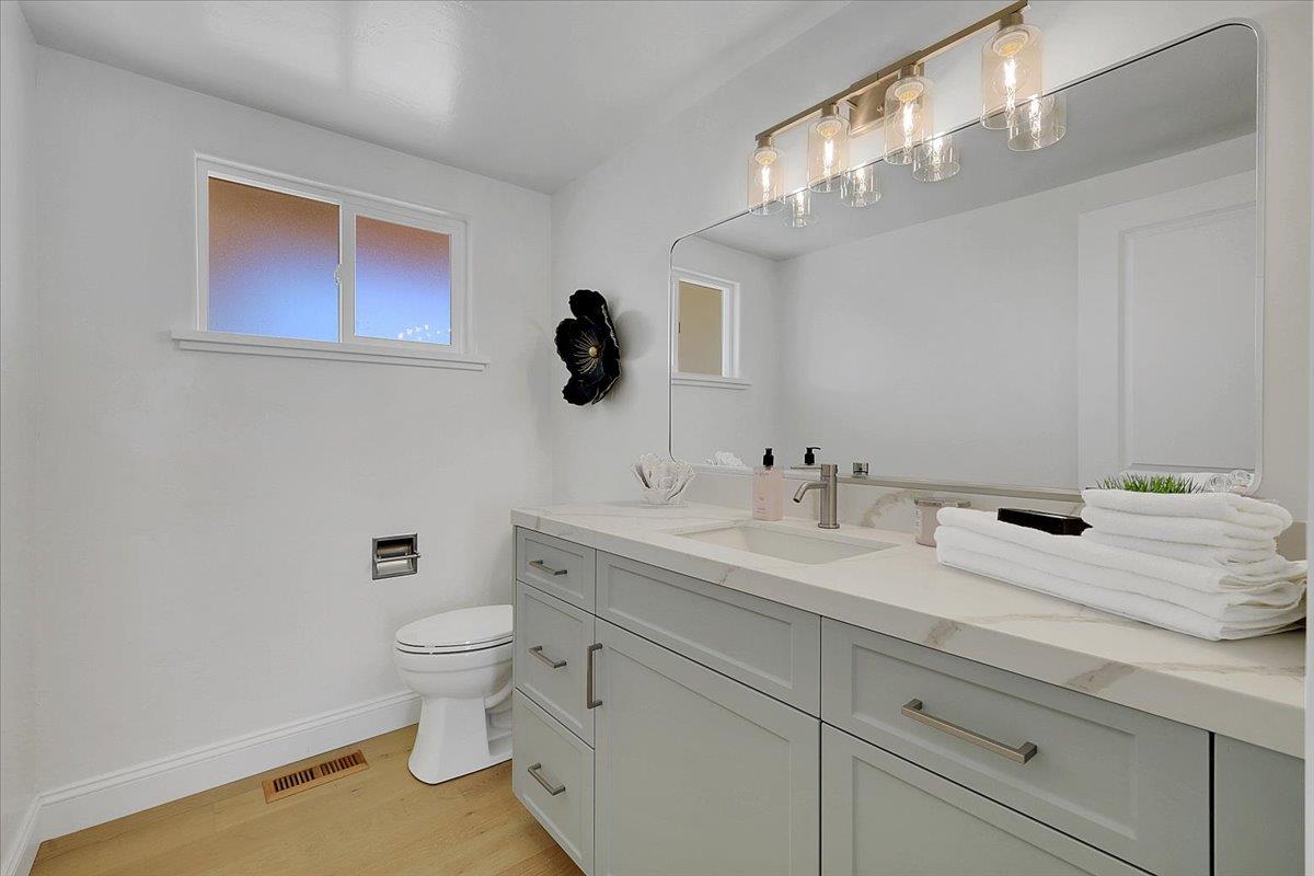 1181 Barry Road Yuba City, CA 95991 - Photo 28 of 60 a spacious bathroom with a toilet sink and mirror