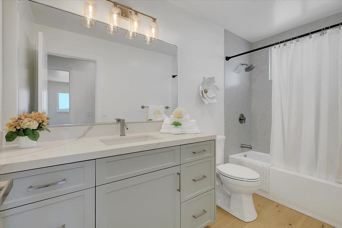 1181 Barry Road Yuba City, CA 95991 - Photo 31 of 60 a bathroom with a sink a toilet and a large mirror