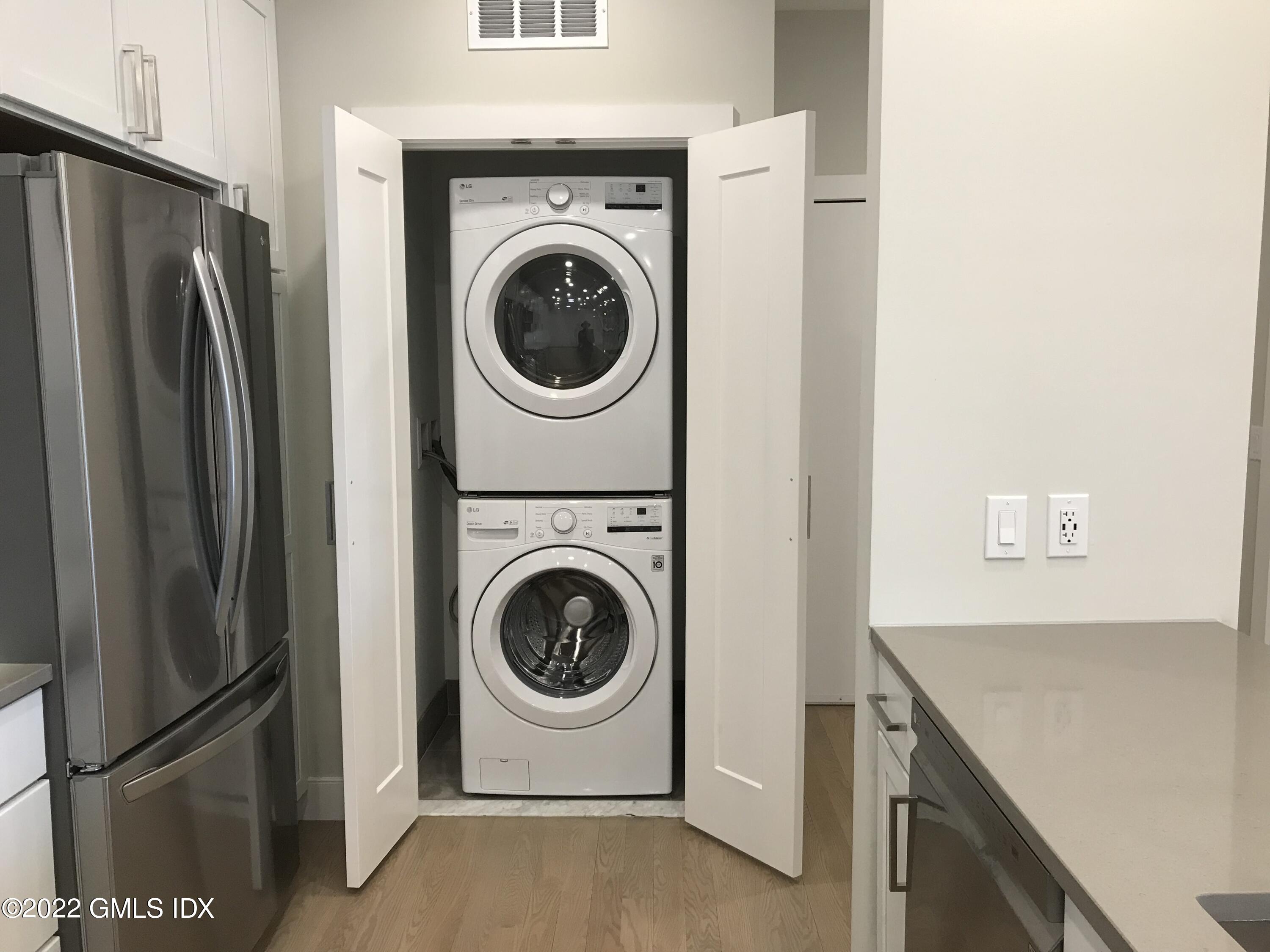 56 Old Field Point Road, Unit 1 Greenwich, CT 06830 - Photo 13 of 30 a kitchen with a refrigerator and washer