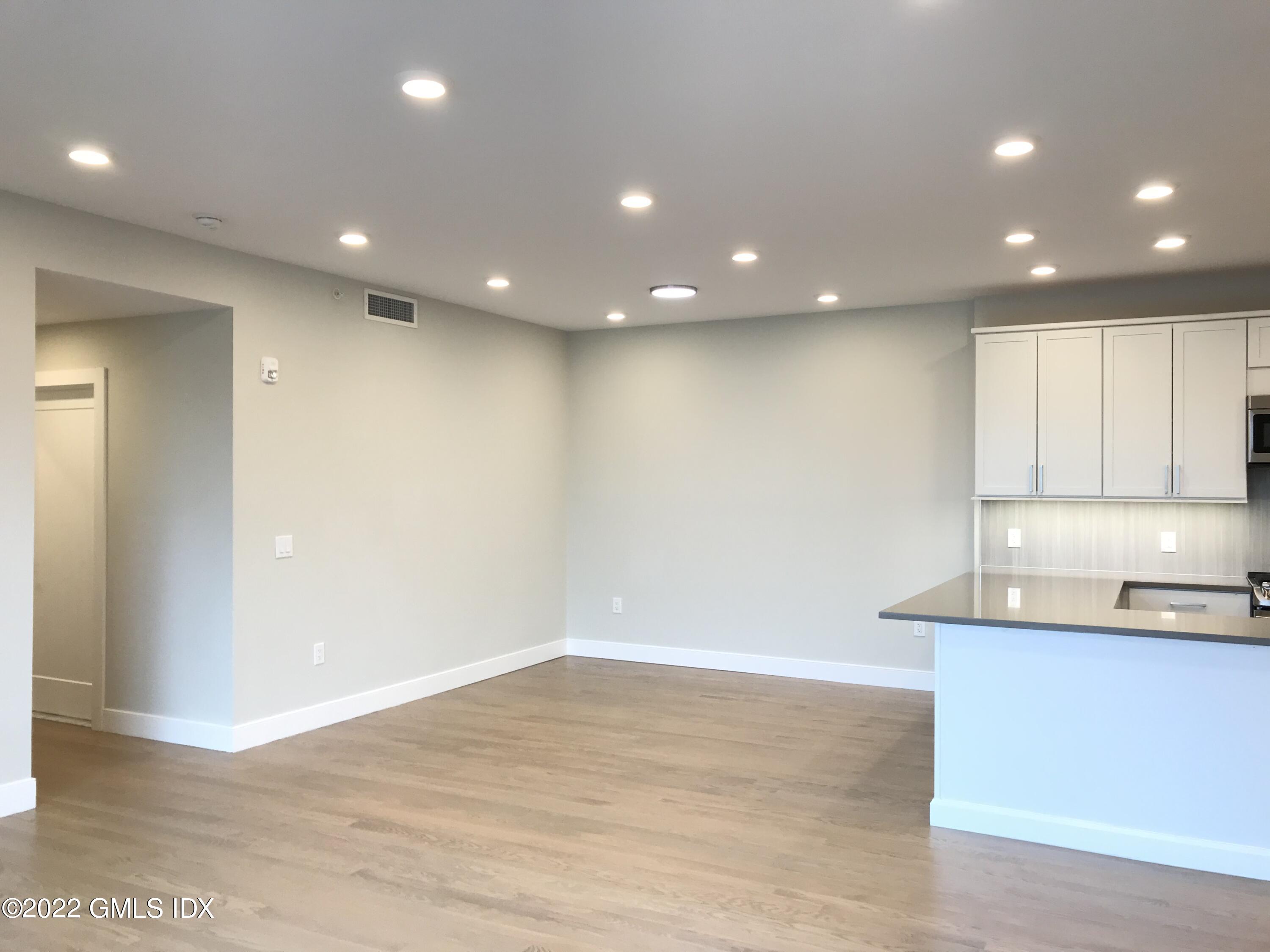 56 Old Field Point Road, Unit 1 Greenwich, CT 06830 - Photo 18 of 30 a big room with wooden floor