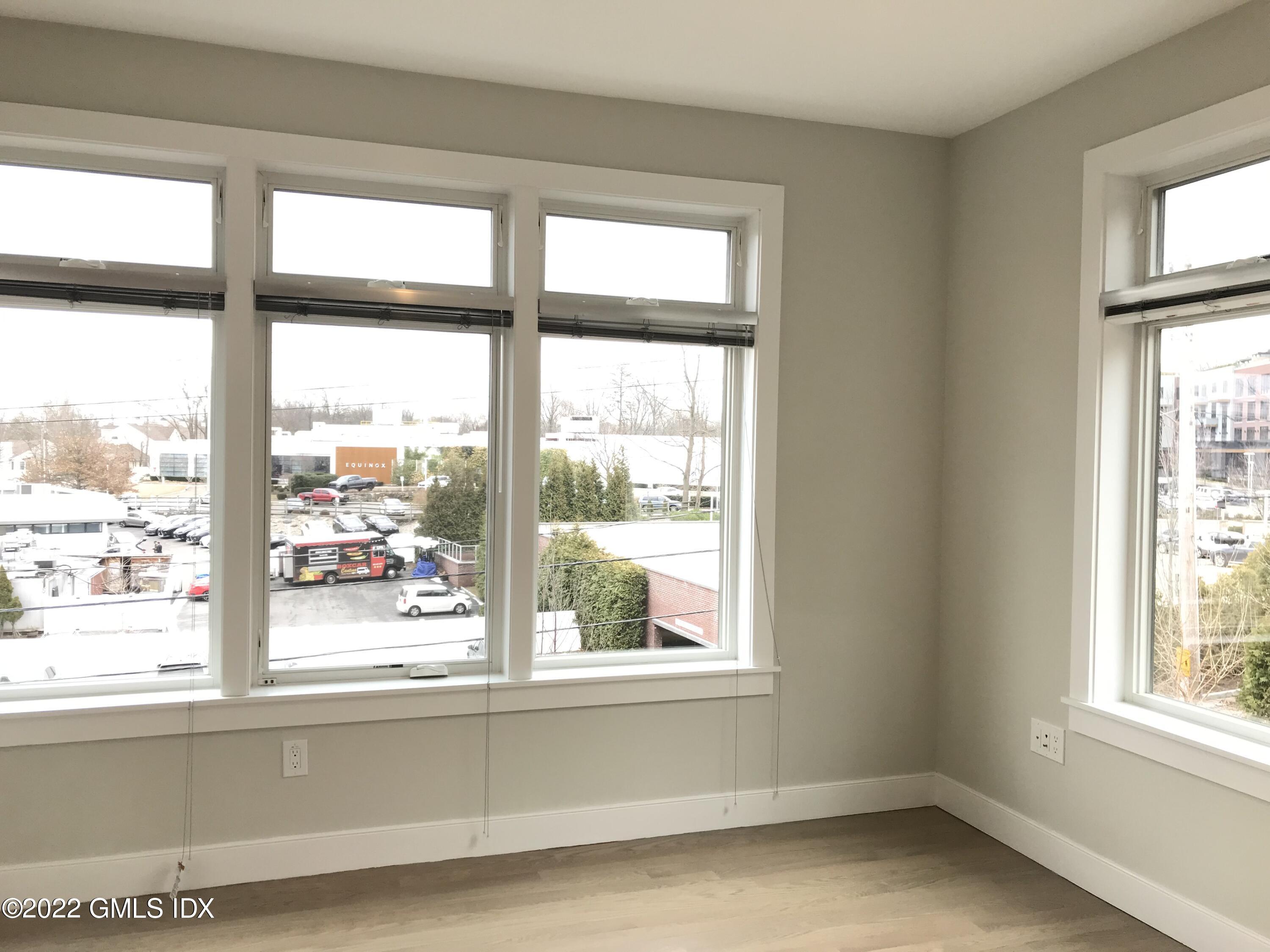 56 Old Field Point Road, Unit 1 Greenwich, CT 06830 - Photo 19 of 30 a view of empty room with windows
