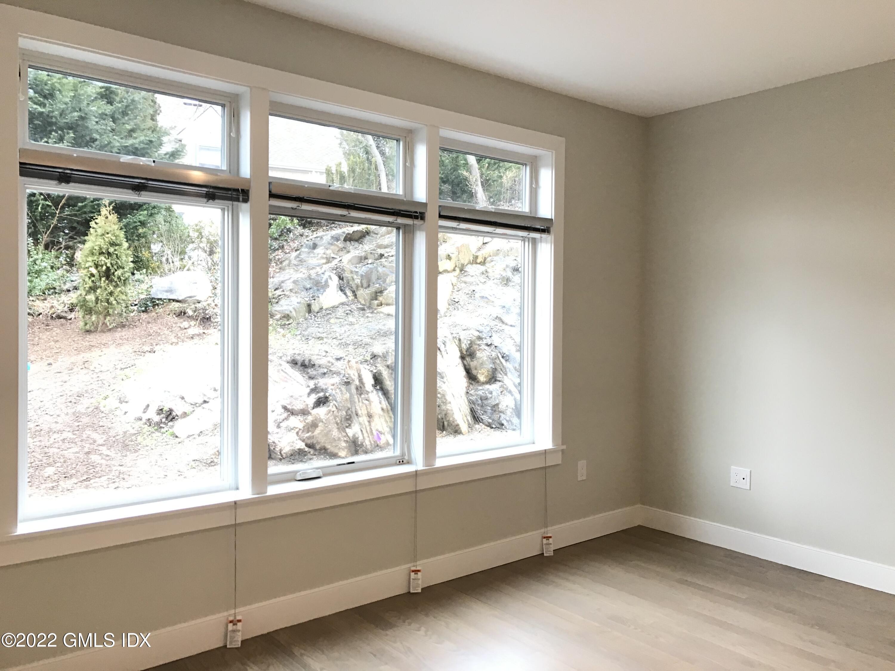 56 Old Field Point Road, Unit 1 Greenwich, CT 06830 - Photo 23 of 30 a view of an empty room with a window