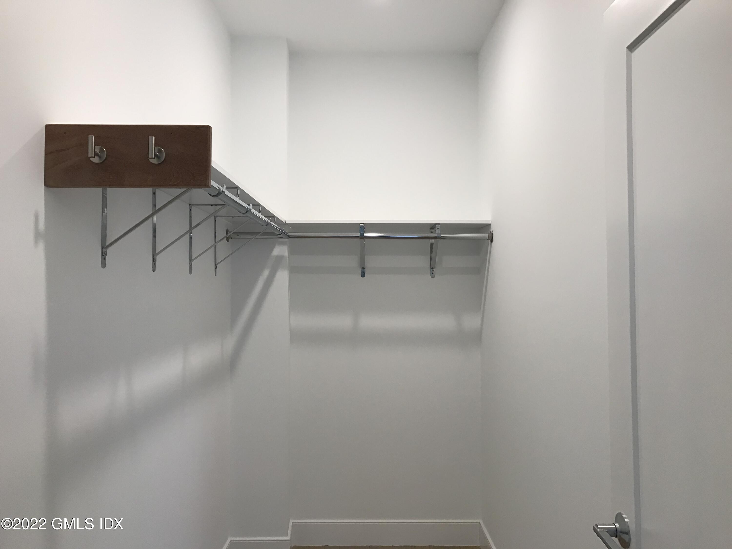 56 Old Field Point Road, Unit 1 Greenwich, CT 06830 - Photo 26 of 30 a view of staircase with white walls