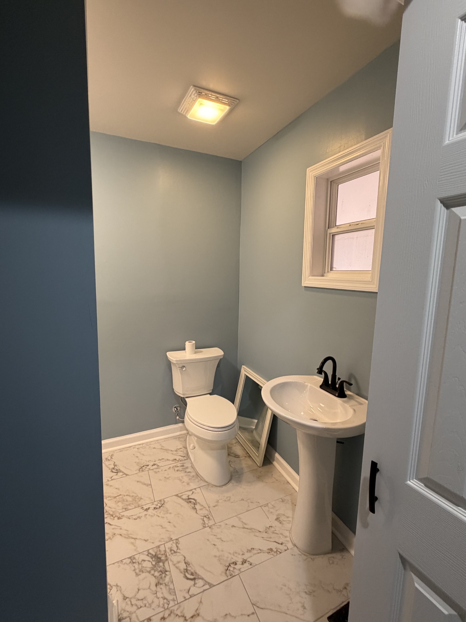 4973 Awalt Road Tullahoma, TN 37388 - Photo 11 of 40 a white toilet sitting next to a bathroom sink