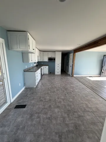 a view of a kitchen with a sink and cabinets