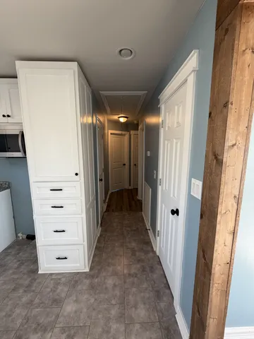 a view of walk in closet with white walls