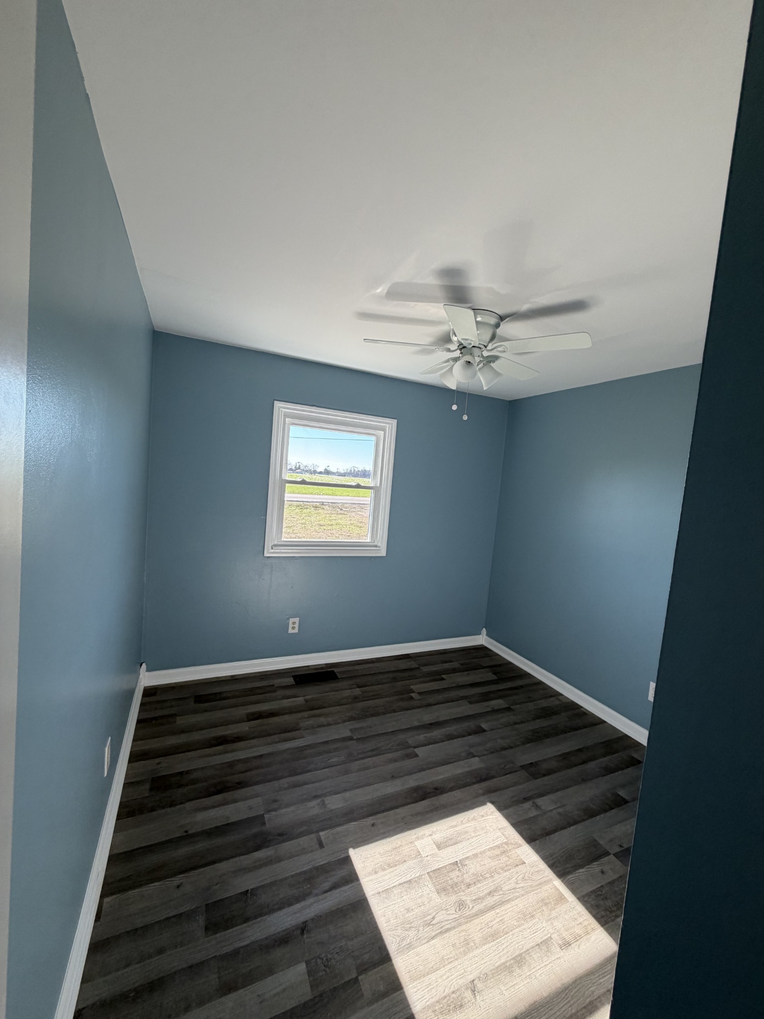 4973 Awalt Road Tullahoma, TN 37388 - Photo 20 of 40 a view of an empty room with wooden floor and a window