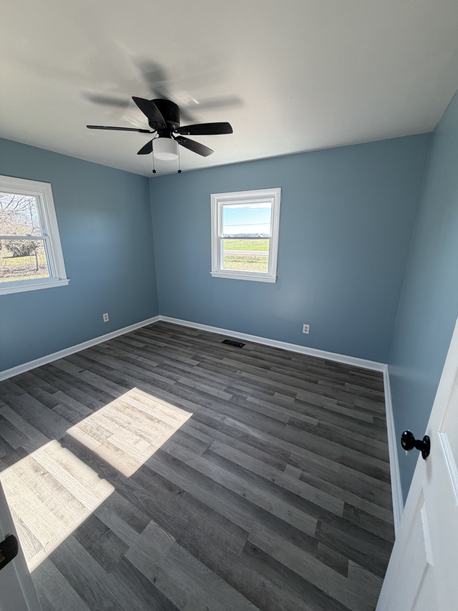 4973 Awalt Road Tullahoma, TN 37388 - Photo 21 of 40 a view of an empty room with wooden floor and a window