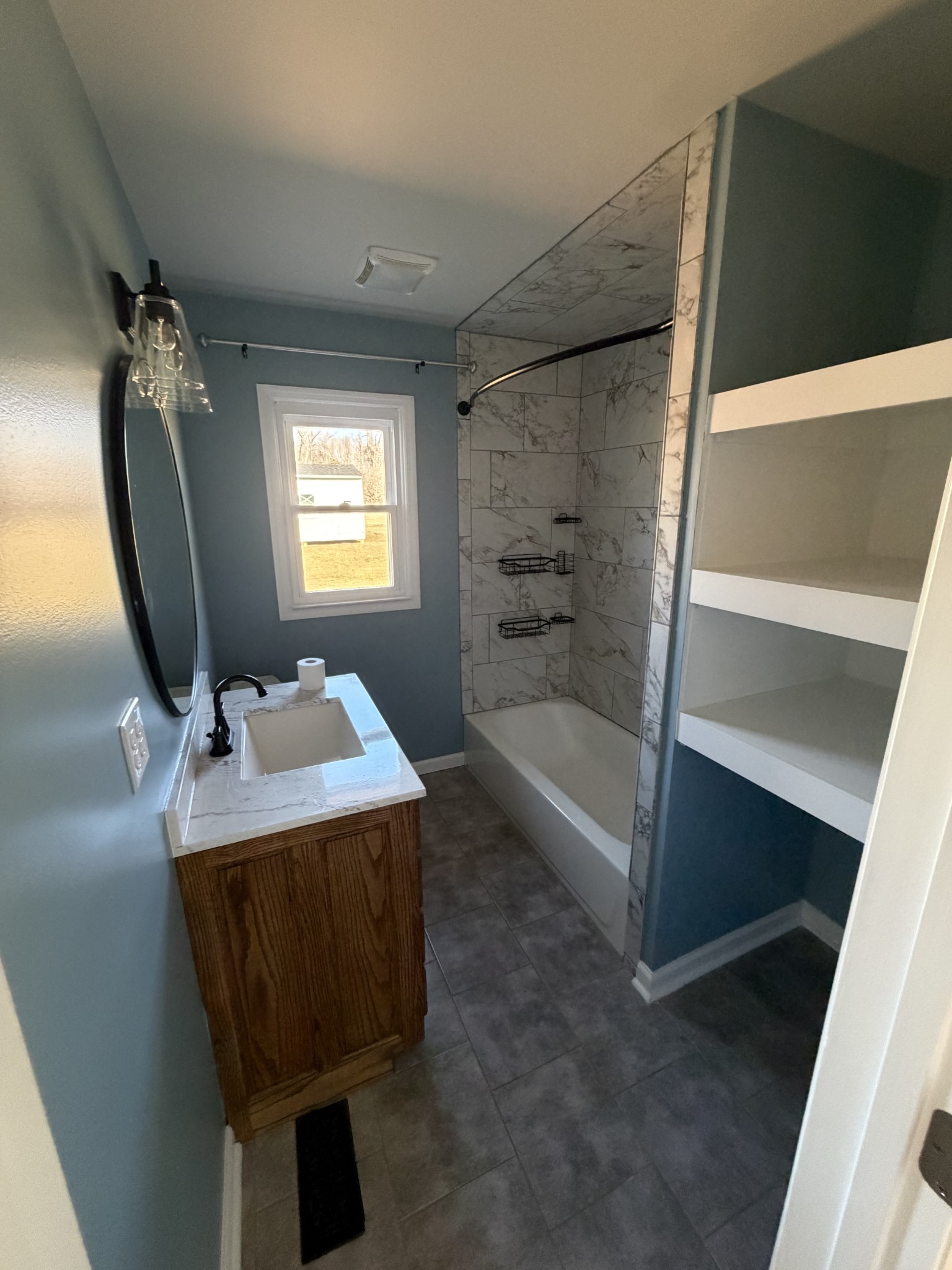 4973 Awalt Road Tullahoma, TN 37388 - Photo 25 of 40 a bathroom with a tub sink and mirror