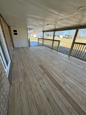 a view of an outdoor space with wooden floor