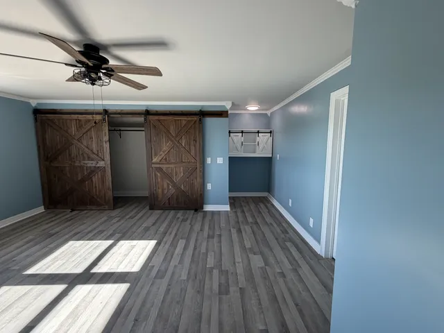 a view of empty room with wooden floor
